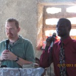 Dave sharing in a Haitian church with translator, Marc.